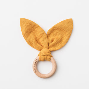 Bunny Ears Baby Teether in Saffron made from organic cotton muslin and natural beechwood. Relieve the pain of your babies teething naturally.